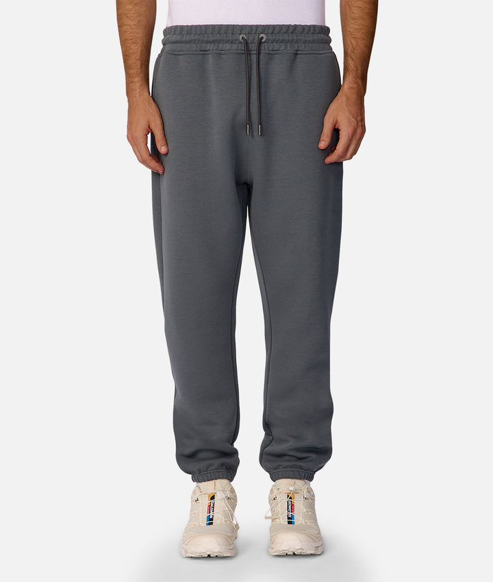 Person wearing gray sweatpants on a white background