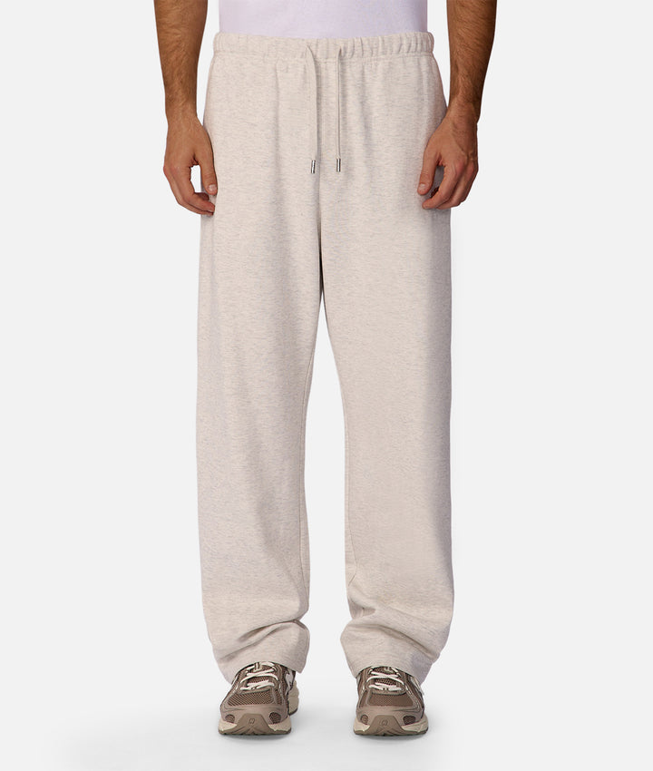 Person wearing beige sweatpants on a white background