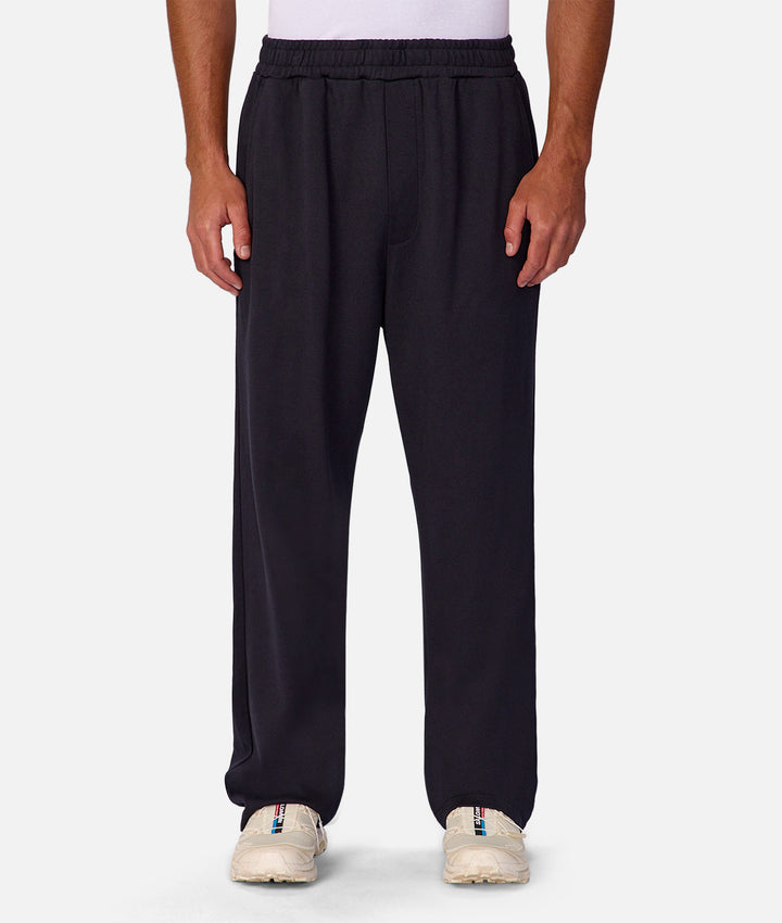 Person wearing black pants on a white background