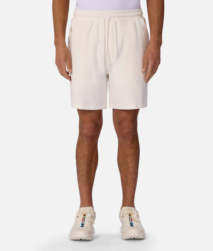 Person wearing white shorts on a white background