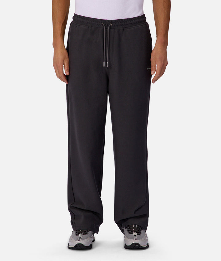 Black pants worn by a person on a white background