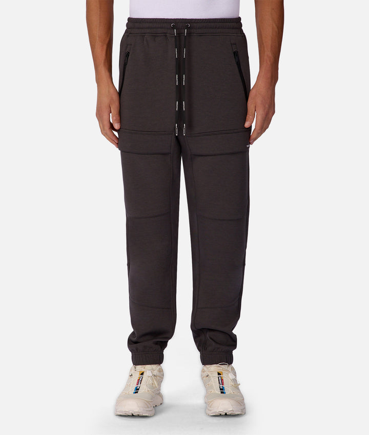 Dark brown cargo pants worn by a person on a white background