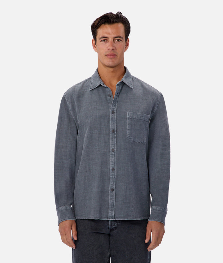 Man wearing a blue denim shirt on a white background