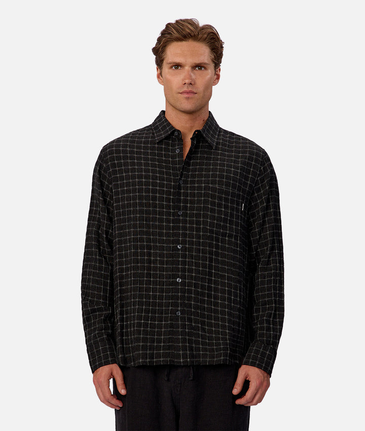 Man wearing a black plaid shirt on a white background