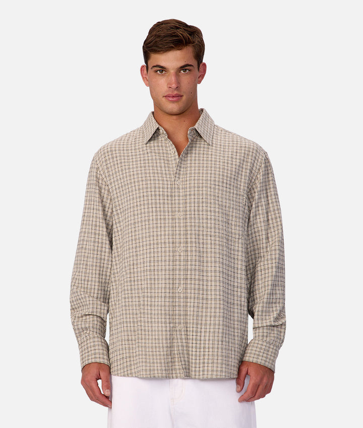 Man wearing a plaid shirt on a white background