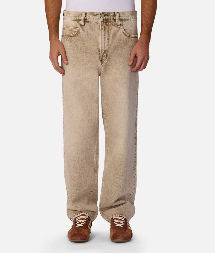 Beige jeans worn by a person on a white background