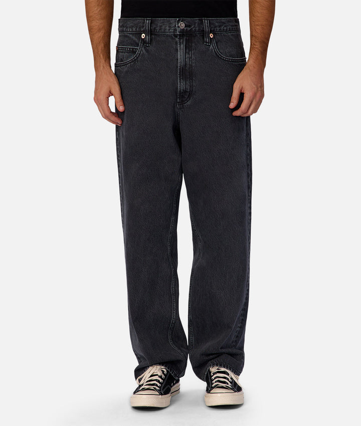Person wearing black jeans on a white background