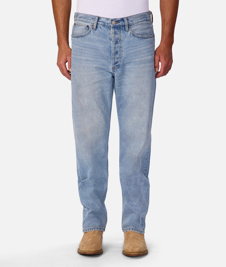 Light blue jeans worn by a person on a white background