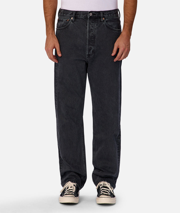 Person wearing black jeans on a white background