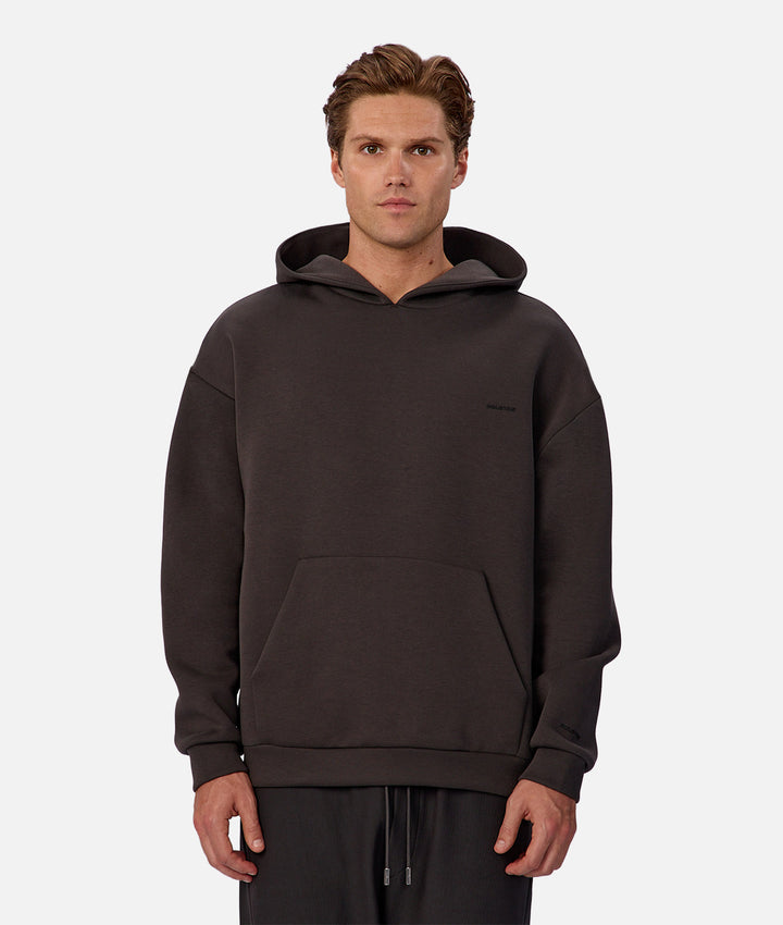 Man wearing a dark brown hoodie on a white background