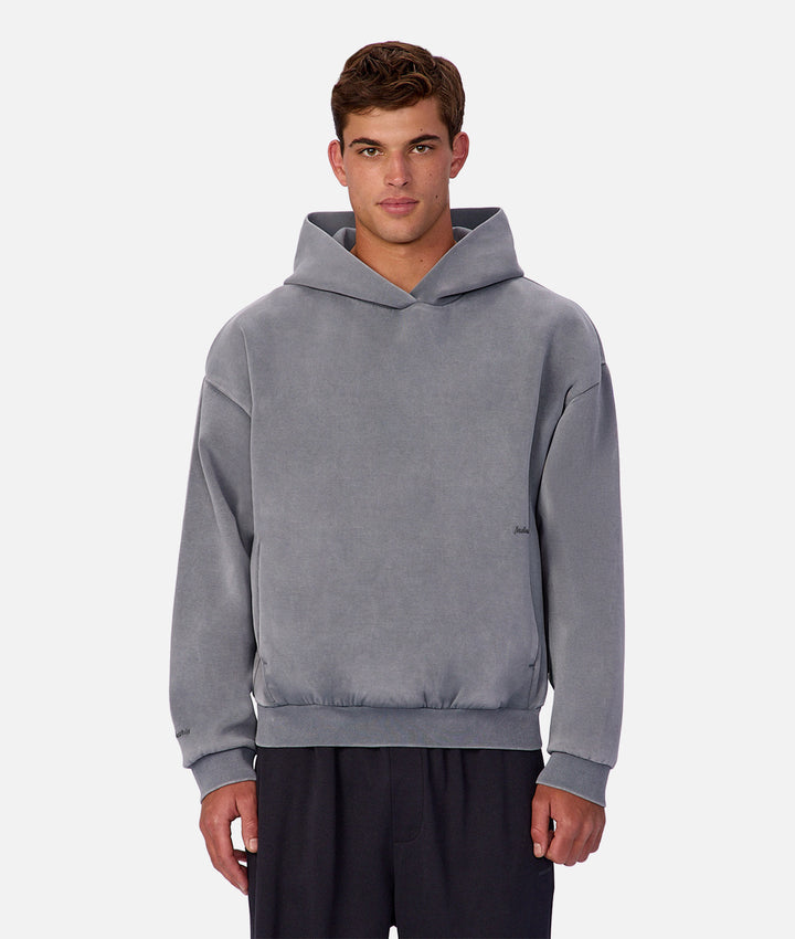 Man wearing a gray hoodie on a white background