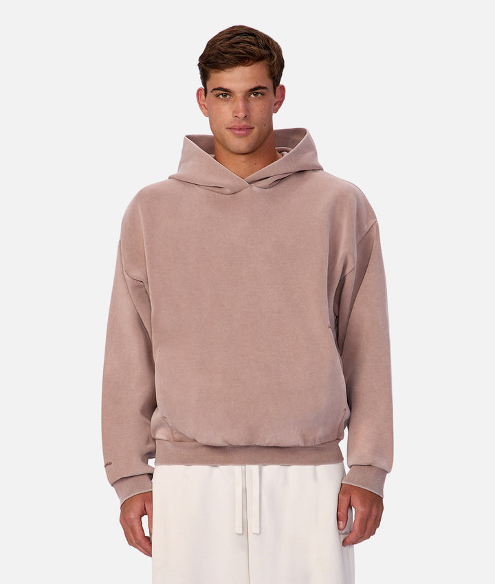 Man wearing a mauve hoodie on a white background