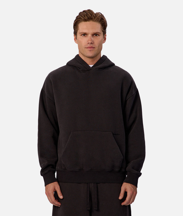 Man wearing a black hoodie on a white background
