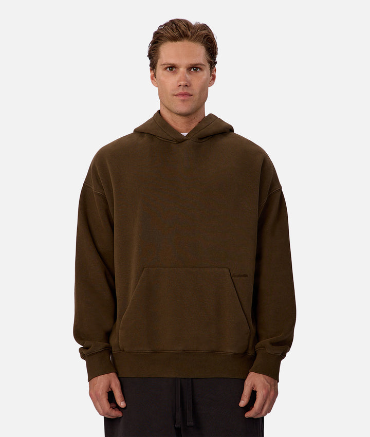 Man wearing a brown hoodie on a white background