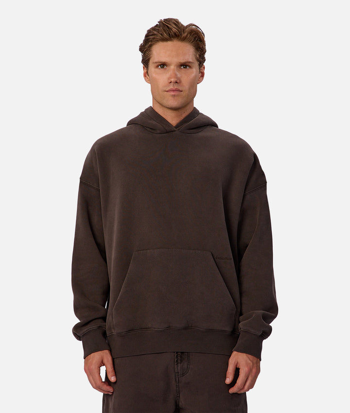 Man wearing a brown hoodie on a white background