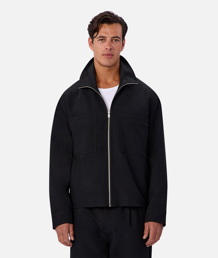 Man wearing a black jacket on a white background