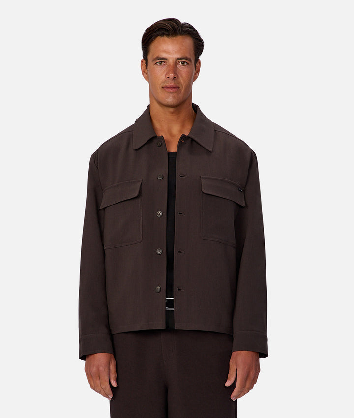 Man wearing a brown jacket on a white background