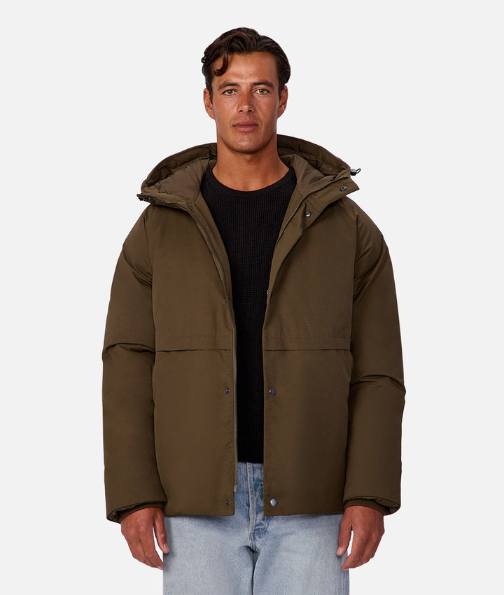 Man wearing a brown jacket on a white background