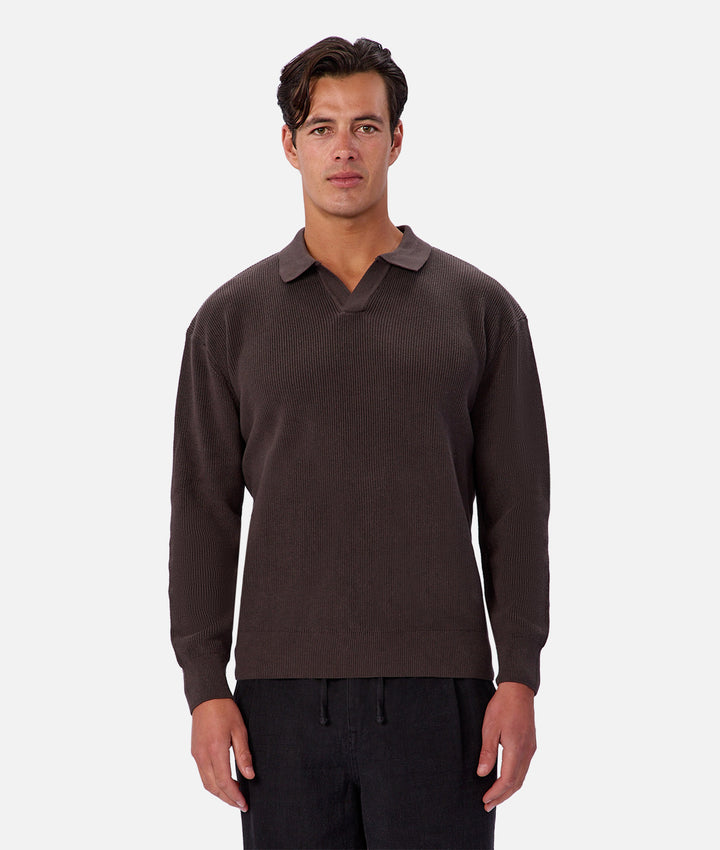 Man wearing a brown sweater with a collar on a white background