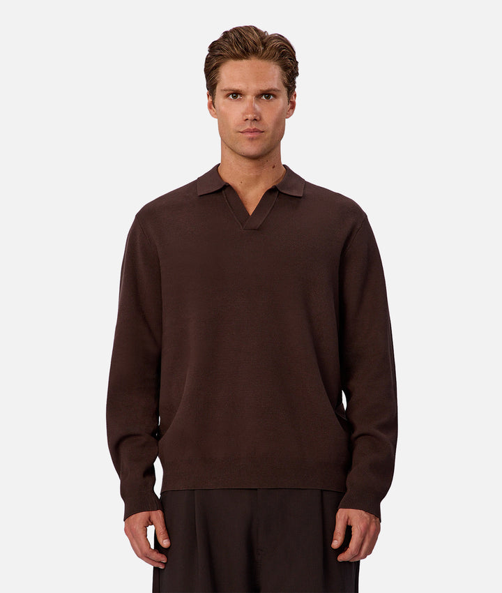 Man wearing a brown long-sleeve shirt against a white background
