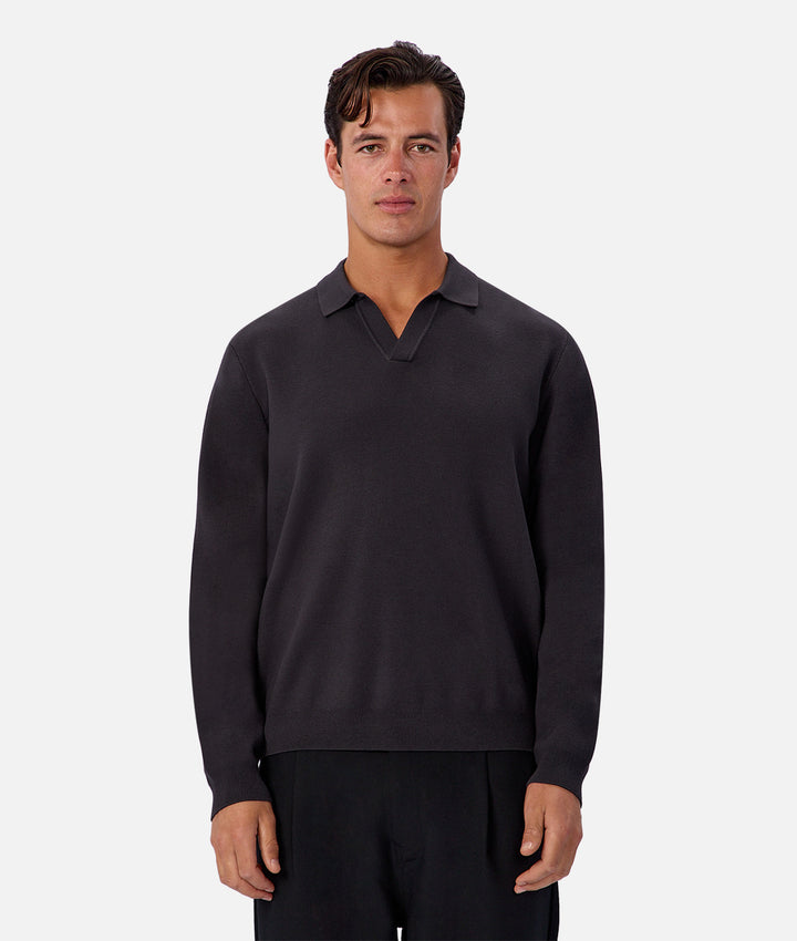 Man wearing a dark gray long-sleeve shirt on a white background