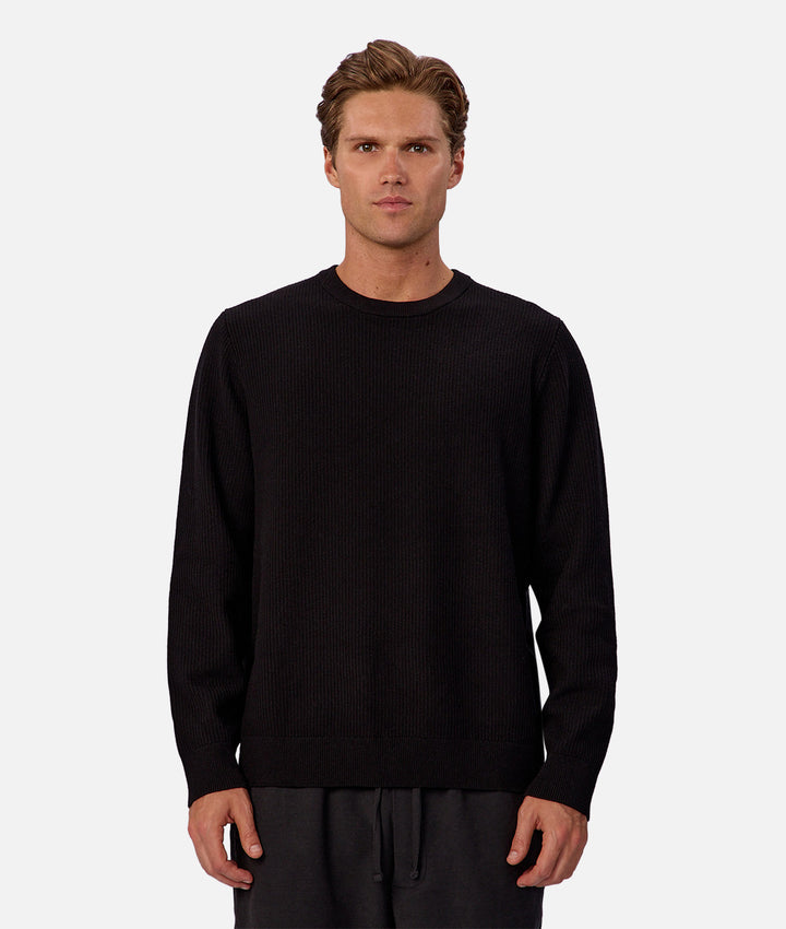 Man wearing a black sweater on a white background