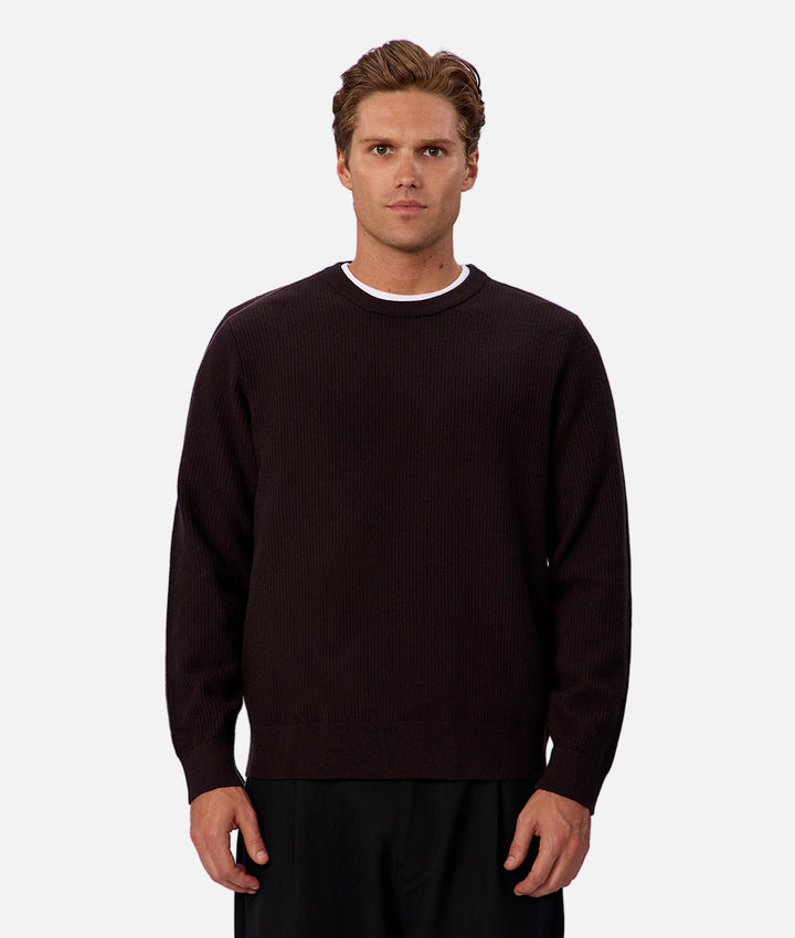Man wearing a black sweater on a white background
