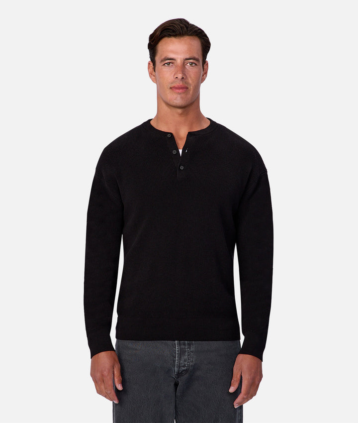 Man wearing a black long-sleeve shirt on a white background