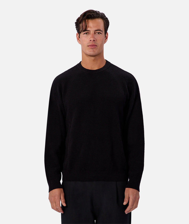 Man wearing a black sweater on a white background