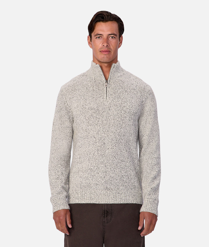 Man wearing a gray marled sweater on a white background