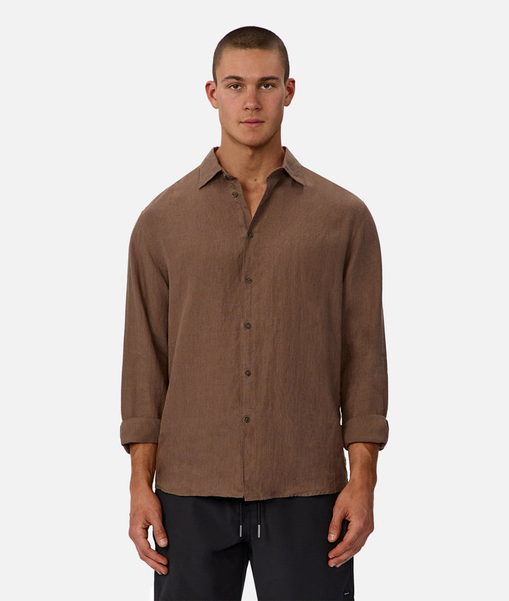Man wearing a brown button-up shirt on a white background