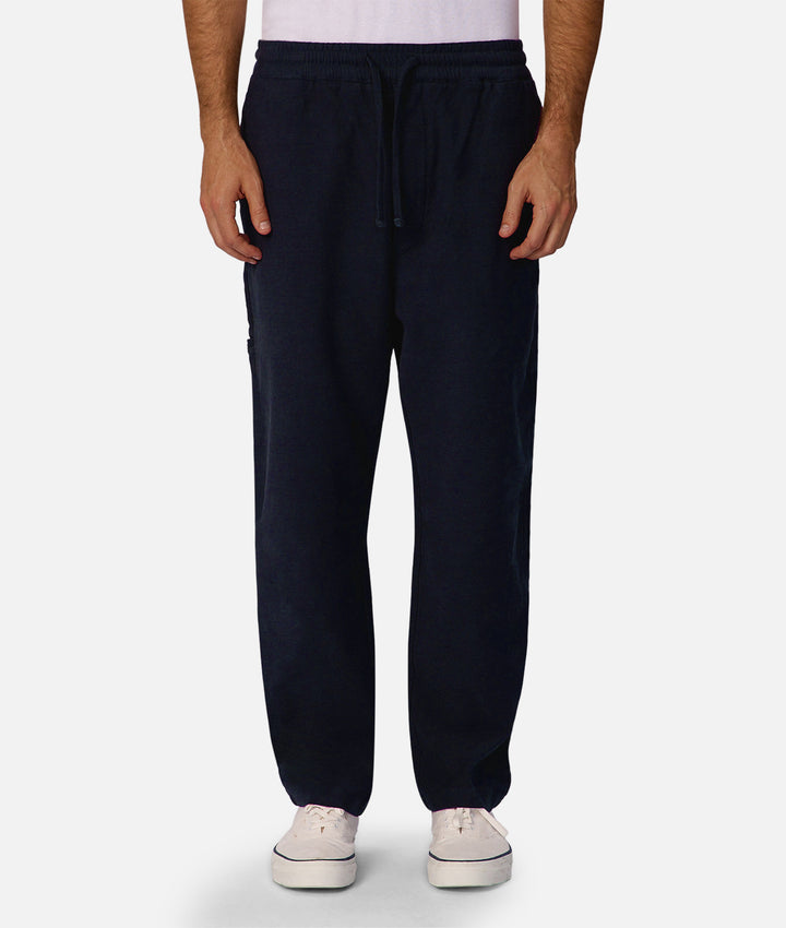 Navy blue sweatpants worn by a person on a white background