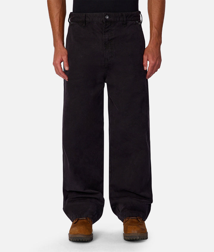 Black pants worn by a person on a white background