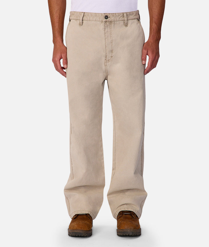 Beige pants worn by a person on a white background