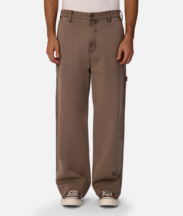 Brown pants worn by a person on a white background