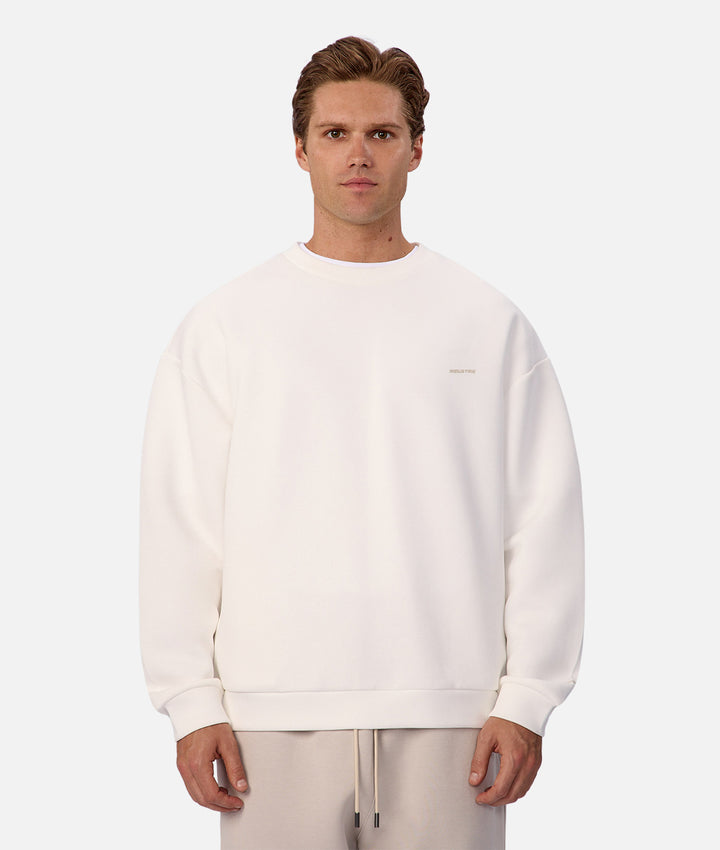 Man wearing a white sweatshirt on a plain background