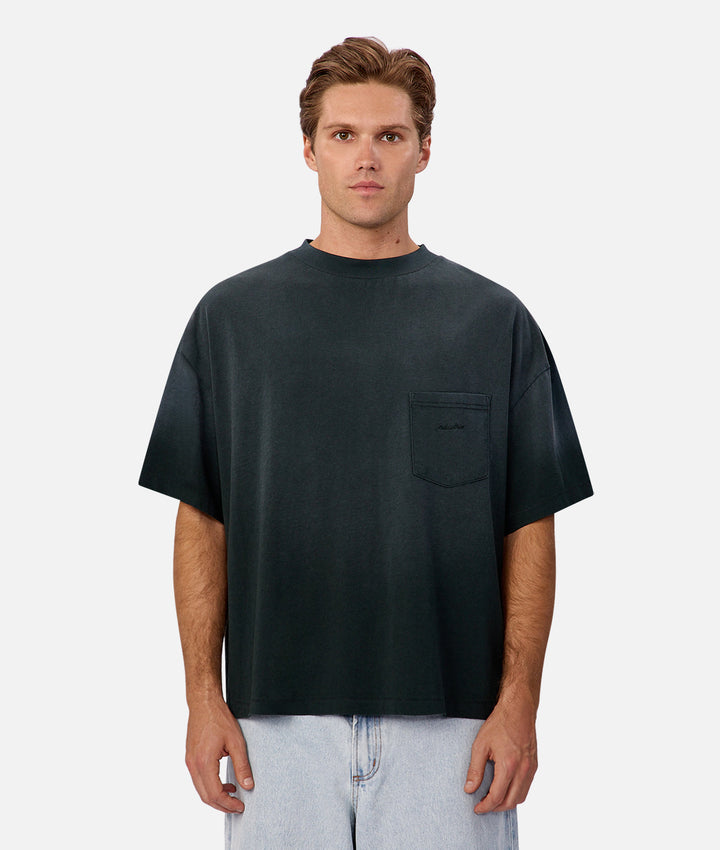 Man wearing a black t-shirt with a pocket on a white background