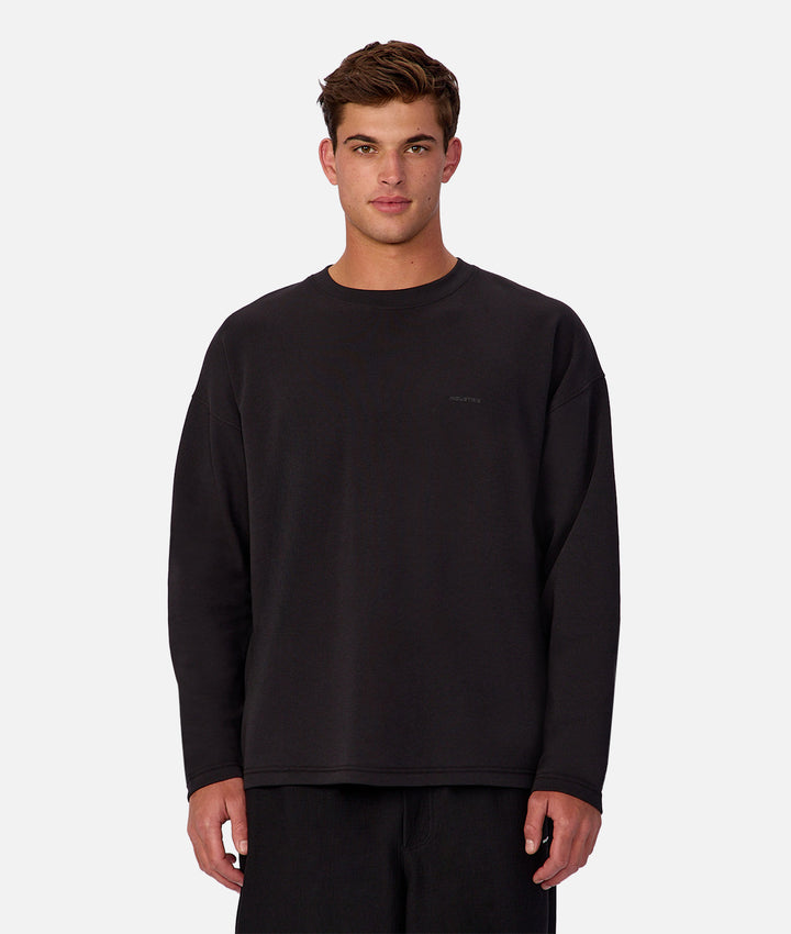 Man wearing a black long-sleeve shirt on a white background