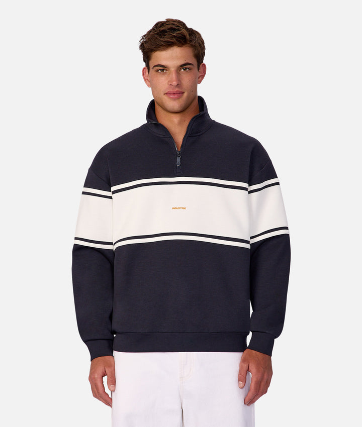 Man wearing a navy and white striped sweater on a white background