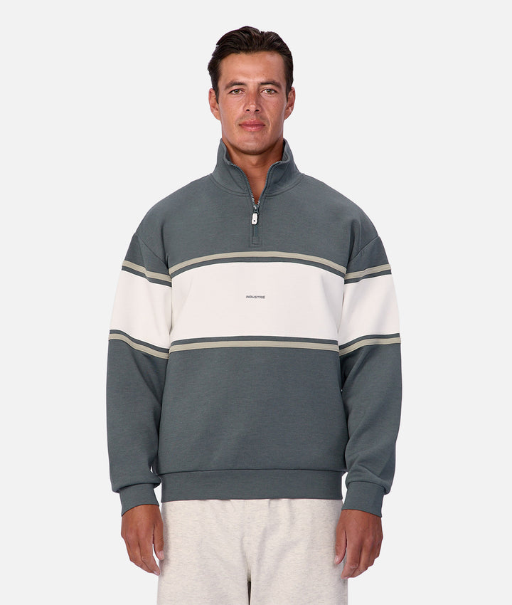 Man wearing a gray and white striped sweater on a white background