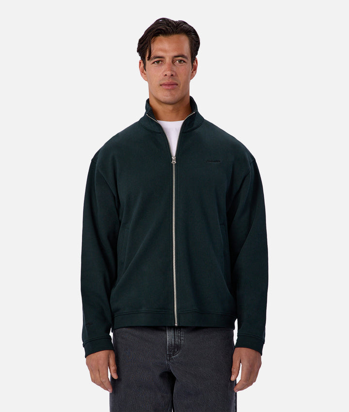 Man wearing a dark green quarter-zip sweatshirt on a white background